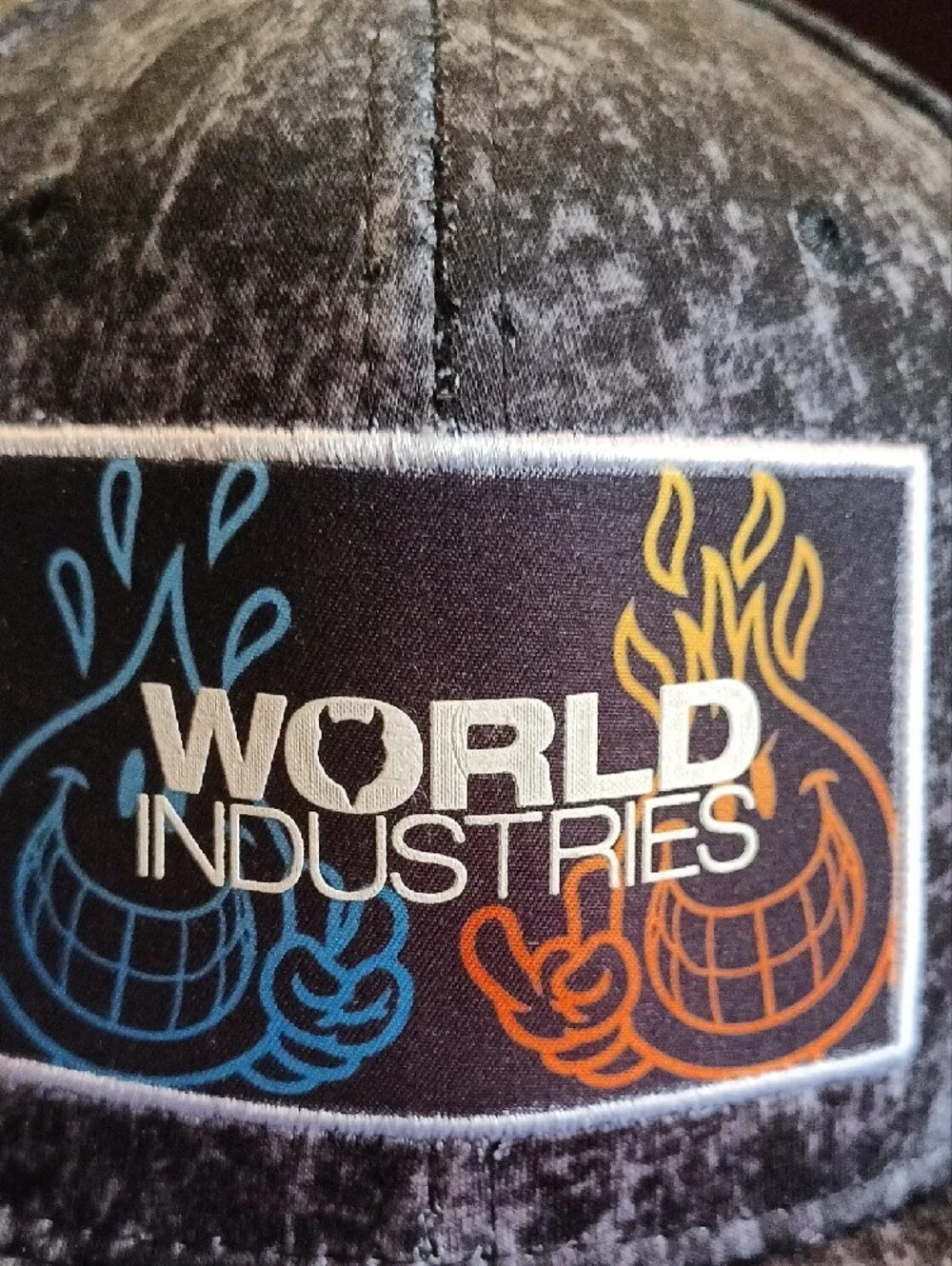 World Industries black acid wash snapback hat featuring an embroidered patch